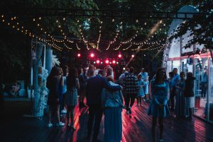 Elegant Outdoor Wedding Reception with Hanging Light Bulbs